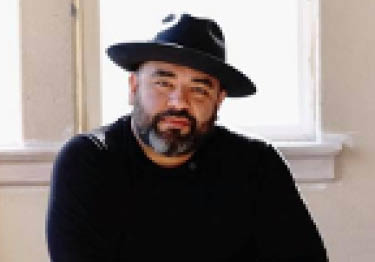 Juan Luiz Guzman wearing hat