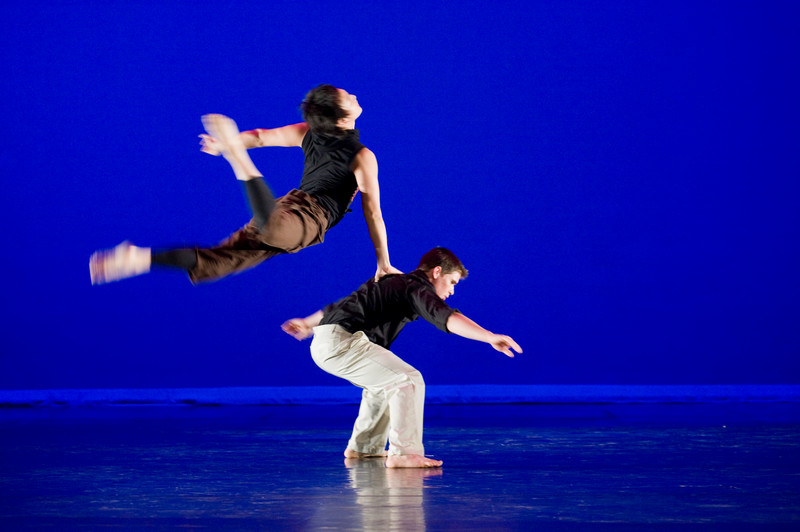 Intermediate Ballet Technique class dancer flying off back of another dancer          duet using chair as a prop          confetti in air, dancers showing exuberance          dancers in Chinese folk fan dance          dancers making a group shape that is reaching for light          dancers holding umbrellas upward, with delight          duet dancing with sofa          duet in soft blue light, making a pose          dancers on stage in blue light in a lunge          dancers in circle surrounding a soloist          duet dancing in soft blue light in a curved shaped pose          duet in a lift