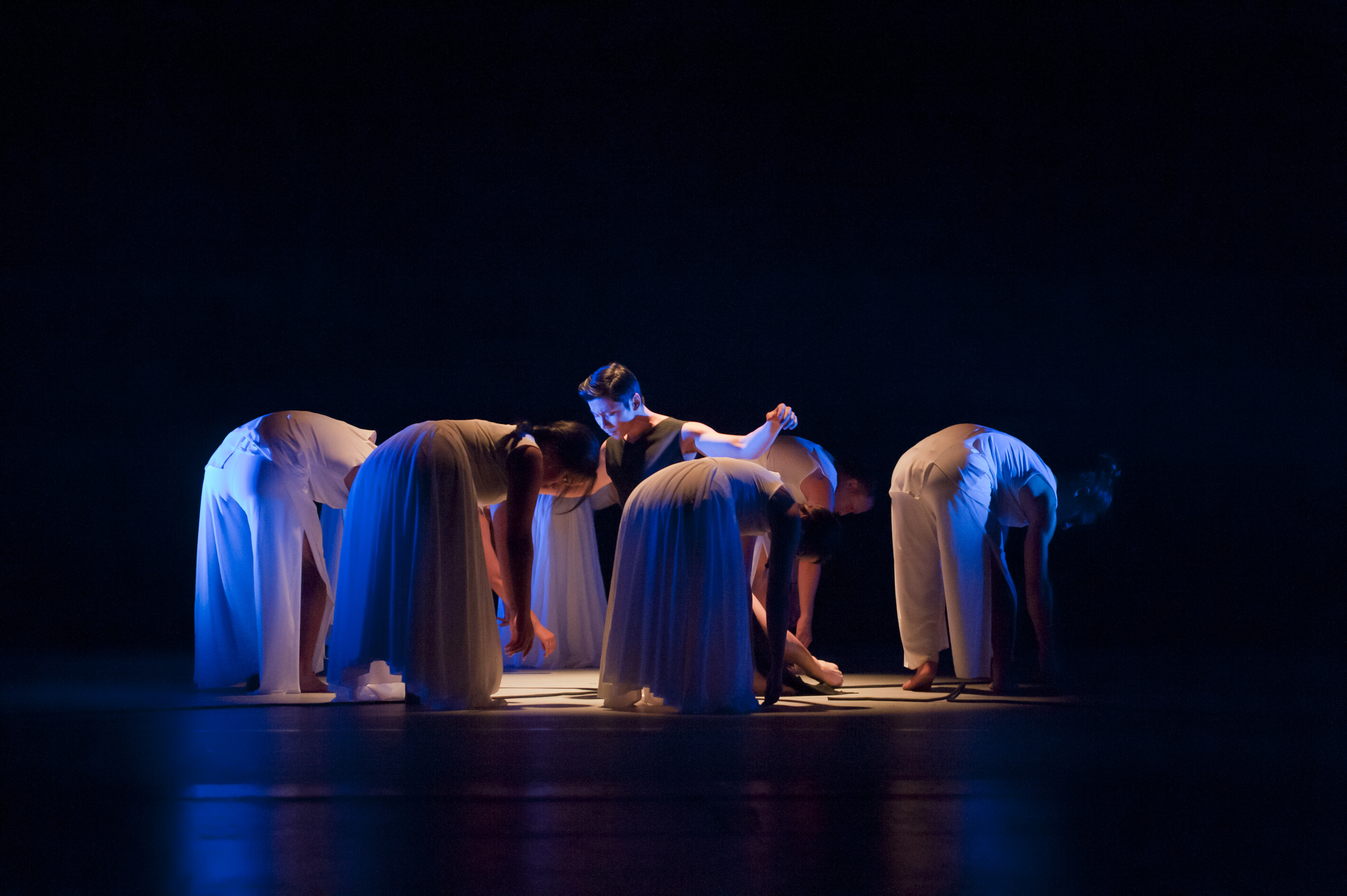 Need descriptions for each of the images       Intermediate Ballet Technique class          dancer flying off back of another dancer          duet using chair as a prop          confetti in air, dancers showing exuberance          dancers in Chinese folk fan dance          dancers making a group shape that is reaching for light          dancers holding umbrellas upward, with delight          duet dancing with sofa          duet in soft blue light, making a pose          dancers on stage in blue light in a lunge          dancers in circle surrounding a soloist          duet dancing in soft blue light in a curved shaped pose          duet in a lift
